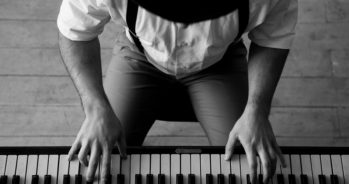 Black and white top view image of man playing piano